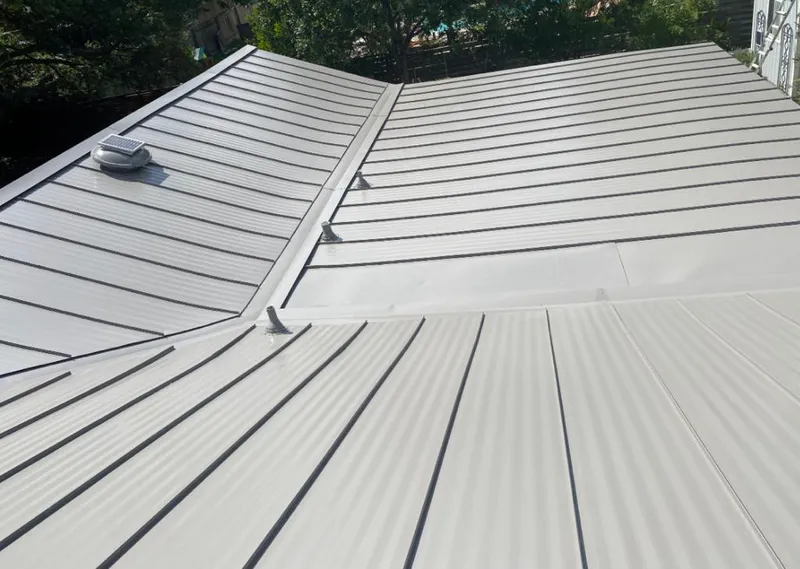 Solar attic fan installed on a metal roof for Roof Ventilation in Elkhorn