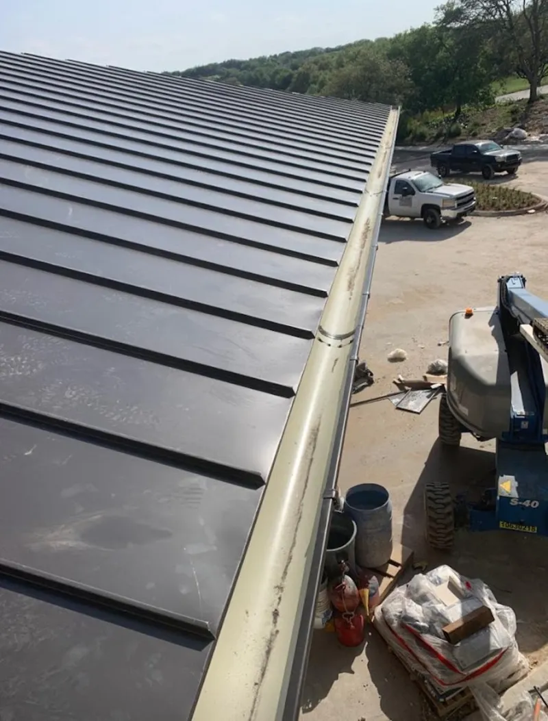 Standing seam panel and gutter detail on a metal roofing jobsite in Elkhorn